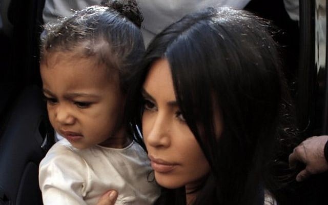 US reality TV star Kim Kardashian carries her daughter, North West, upon arrival at the Armenian St. James Cathedral in Jerusalem's Old City on April 13, 2015. (AFP/Ahmad Gharabli) US reality TV star Kim Kardashian carries her daughter, North West, upon arrival at the Armenian St. James Cathedral in Jerusalem's Old City on April 13, 2015. (AFP/Ahmad Gharabli)
