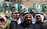 Portraits of members of the Hamas terror group who are jailed in Israeli prisons, seen during a demonstration in their support in the West Bank city of Hebron, on April 15, 2015. (photo credit: AFP PHOTO/HAZEM BADER)