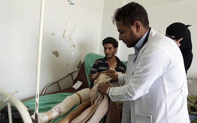 A Yemeni man, wounded in an air strike by Saudi-led coalition warplanes, receives treatment at a hospital in the capital Sanaa on April 21, 2015. (photo credit: AFP/MOHAMMED HUWAIS) 
