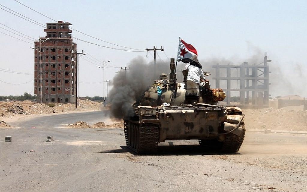 Armed militiamen, allied to fugitive President Abedrabbo Mansour Hadi, man a tank during clashes with opponents and Huthi rebels in the port city of Aden's Dar Saad suburb, on April 22, 2015. (photo credit:  AFP PHOTO / SALEH AL-OBEIDI)