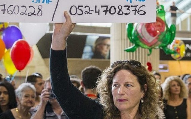Or's mother, Orit, holds up a banner reading "Who saw Or Asraf in the Langtang region?" as families wait for relatives who returned from Nepal on April 28, 2015, at Ben Gurion Airport (photo credit: AFP PHOTO / JACK GUEZ) Or's mother, Orit, holds up a banner reading "Who saw Or Asraf in the Langtang region?" as families wait for relatives who returned from Nepal on April 28, 2015, at Ben Gurion Airport (photo credit: AFP PHOTO / JACK GUEZ)