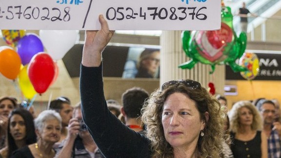 Orit Asraf holds up a banner reading "Who saw Or Asraf in the Langtang region?" as families wait for relatives who returned from Nepal on April 28, 2015, at Ben Gurion Airport (photo credit: AFP PHOTO / JACK GUEZ) Orit Asraf holds up a banner reading "Who saw Or Asraf in the Langtang region?" as families wait for relatives who returned from Nepal on April 28, 2015, at Ben Gurion Airport (photo credit: AFP PHOTO / JACK GUEZ)