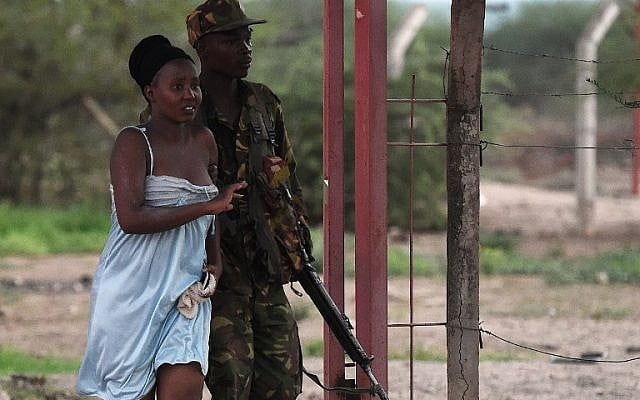 A member of the security forces escorts a student off the campus of Garissa University College after an attack by Somalia's al-Qaeda-linked al-Shabab gunmen, April 2, 2015. (photo credit: AFP/Carl de Souza) A member of the security forces escorts a student off the campus of Garissa University College after an attack by Somalia's al-Qaeda-linked al-Shabab gunmen, April 2, 2015. (photo credit: AFP/Carl de Souza)