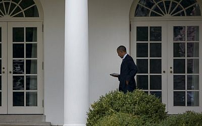 US President Barack Obama looks at a tablet while walking to the West Wing of the White House in Washington, DC,  on April 7, 2015. (photo credit: AFP/Brendan Smialowski)