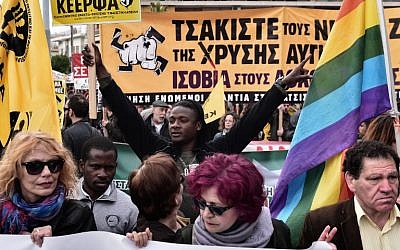 Anti-racism groups and unions join a protest outside the high security prison in Korydallos, near Athens,  where the trial of 69 members of the Greek extreme right Golden Dawn party started, April 20, 2015. (photo credit: AFP/Louisa Gouliamaki)