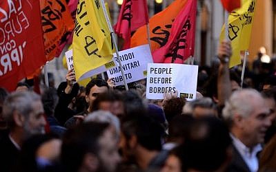 Demonstrators protest immigration policy and border management in front of the Italian parliament in Rome's Montecitorio Square on April 21, 2015. Various associations, trade unions and activists gathered on April 21 in front of the Italian parliament to ask for humanitarian commitment in the wake of last weekend's migrant boat disaster in which 800 are feared to have drowned after a fishing boat that had been crammed with migrants trying to reach Europe capsized off Libya's coast . (Filippo Monteforte/AFP)