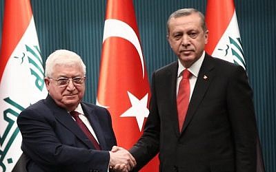 Turkish President Recep Tayyip Erdogan shakes hand with President of Iraq Fouad Massoum before a press conference in Ankara, on April 22, 2015. (Photo credit: AFP/ STR)