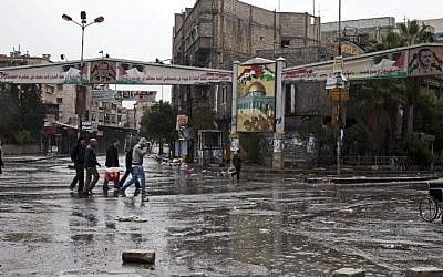 A file picture taken on December 20, 2012 shows residents of the Palestinian refugee camp of Yarmouk in the Syrian capital Damascus returning to their homes after they fled due to rebel fighters. (photo credit: Carole Alfarah/AFP)