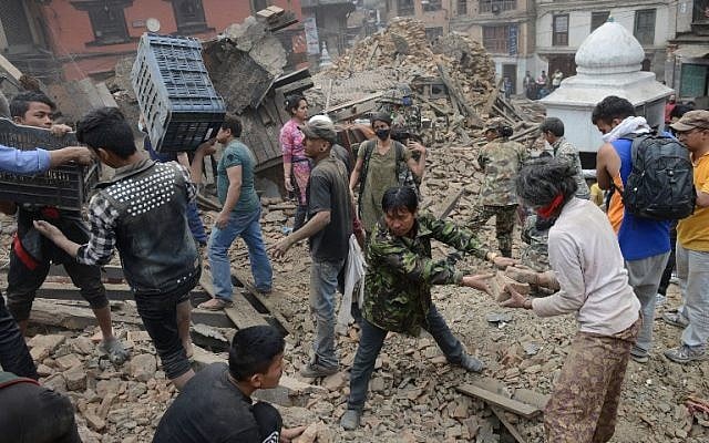 People clear rubble in Kathmandu's Durbar Square, a UNESCO World Heritage Site that was severely damaged by an earthquake on April 25, 2015. (photo credit: AFP/PRAKASH MATHEMA) People clear rubble in Kathmandu's Durbar Square, a UNESCO World Heritage Site that was severely damaged by an earthquake on April 25, 2015. (photo credit: AFP/PRAKASH MATHEMA)
