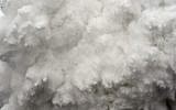 A cloud of snow and debris triggered by an earthquake flies towards Everest Base Camp, moments ahead of flattening part of the camp in the Himalayas, April 25, 2015. (photo credit: AFP/Roberto Schmidt)