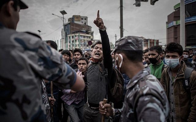 Nepalese riot police officials stand alert on a street in Kathmandu on April 29, 2015, as earthquake survivors desperate to leave the Nepalese capital show their anger after promised special bus services failed to materialize. (photo credit: AFP/Philippe LOPEZ) Nepalese riot police officials stand alert on a street in Kathmandu on April 29, 2015, as earthquake survivors desperate to leave the Nepalese capital show their anger after promised special bus services failed to materialize. (photo credit: AFP/Philippe LOPEZ)