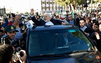 Iranian Foreign Minister Mohammad Javad Zarif greets people as the nuclear negotiating committee arrives at Mehr Abad Airport in Tehran on April 3, 2015, hours after announcing the ingredients of a nuclear deal with world powers. (photo credot: AFP/ISNA/Borna Ghasemi) Iranian Foreign Minister Mohammad Javad Zarif greets people as the nuclear negotiating committee arrives at Mehr Abad Airport in Tehran on April 3, 2015, hours after announcing the ingredients of a nuclear deal with world powers. (photo credot: AFP/ISNA/Borna Ghasemi)