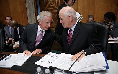 Senate Foreign Relations Committee Chairman Sen. Bob Corker (left) confers with ranking member Sen. Ben Cardin (right) during a committee markup meeting on the proposed nuclear agreement with Iran,  in Washington, DC, April 14, 2015. (Win McNamee/Getty Images/AFP)