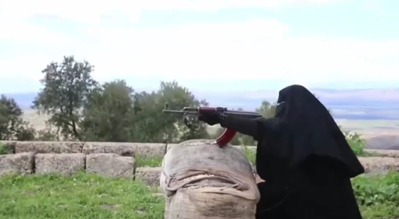 A jihadist woman wielding a Kalashnikov rifle at a training camp near Aleppo, Syria. (screen capture: YouTube)