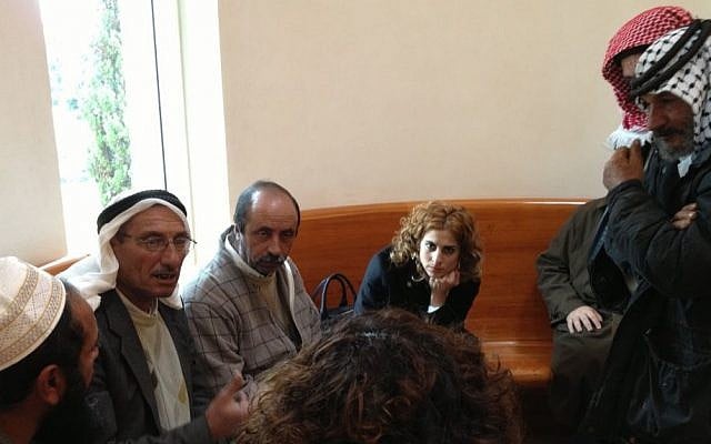 Representatives of Palestinian villages south of Hebron discuss the case with their lawyers at the Supreme Court in Jerusalem, April 12, 2015 photo credit: Elhanan Miller/Times of Israel 