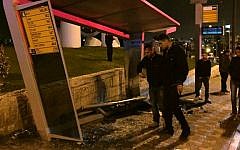 Police investigate the scene where a driver rammed his car into a bus stop in French Hill, Jerusalem, on April 15, 2015. (photo credit: Fire and Rescue Services)