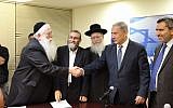 Prime Minister Benjamin Netanyahu shakes hands with UTJ's Meir Porush in the Knesset, on April 29, 2015, after the two parties signed a coalition agreement. To Netanyahu's right is UTJ leader Yaakov Litzman. (Courtesy, Likud Party)