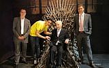 Shimon Peres sits in the Iron Throne of the famed series 'Game of Thrones,' with British Ambassador Matthew Gould on his right, YES CEO Ron Eilon (left) and 17-year old Ben Yuval, an avid fan of the series, who is suffering from a hematological disease and was hosted by Lehoshit Yad Association (Courtesy YES)