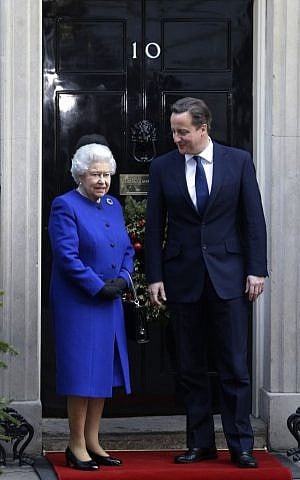 Prime Minister David Cameron greets Queen Elizabeth II at 10 Downing Street, Dec. 18, 2012. (photo credit: AP Photo/Lefteris Pitarakis)