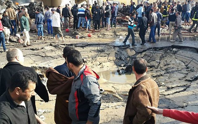 Egyptians gather around the crater following a bombing that struck a main police station in the capital of the northern Sinai province in el-Arish, Egypt, Sunday, April 11, 2015. (AP Photo/Muhamed Sabry) Egyptians gather around the crater following a bombing that struck a main police station in the capital of the northern Sinai province in el-Arish, Egypt, Sunday, April 11, 2015. (AP Photo/Muhamed Sabry)