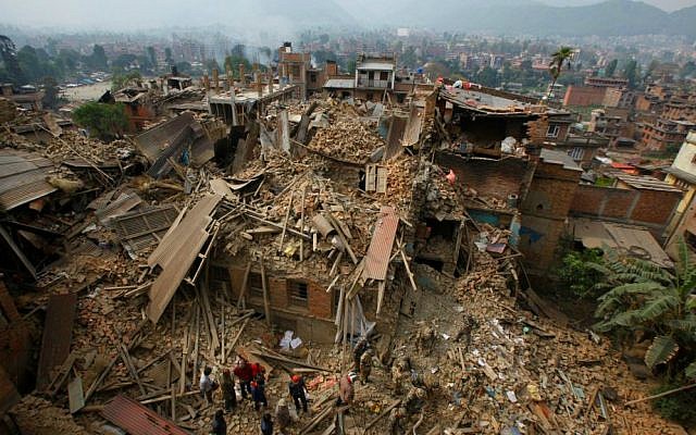 Rescue workers remove debris as they search for victims of earthquake in Bhaktapur near Kathmandu, Nepal, Sunday, April 26, 2015. (AP Photo/Niranjan Shrestha)