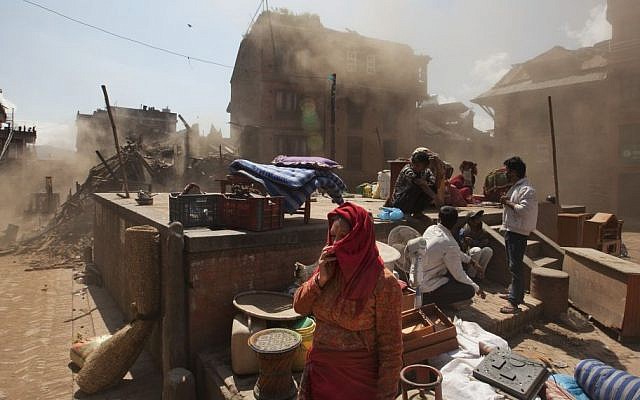 Nepalese residents gather in an open space at the site of destruction caused after Saturday's earthquake in Bhaktapur, on the outskirts of Kathmandu, Nepal, Monday, April 27, 2015. (photo credit: AP/Niranjan Shrestha) Nepalese residents gather in an open space at the site of destruction caused after Saturday's earthquake in Bhaktapur, on the outskirts of Kathmandu, Nepal, Monday, April 27, 2015. (photo credit: AP/Niranjan Shrestha)