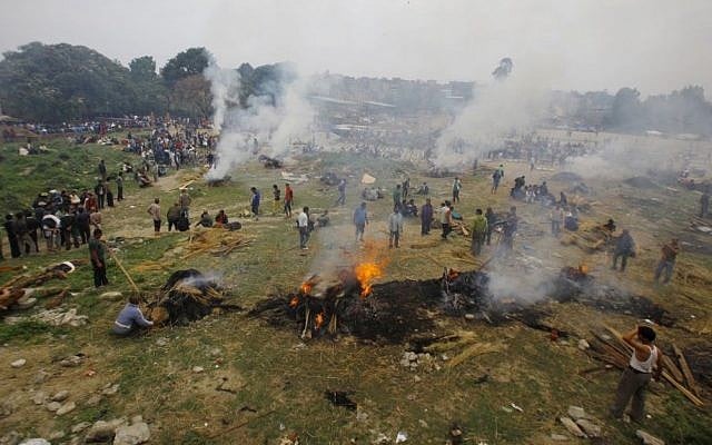 Nepalese people gather to cremate their family members who died in the earthquake in Bhaktapur near Kathmandu, Nepal, Sunday, April 26, 2015. (photo credit: AP/Niranjan Shrestha) 