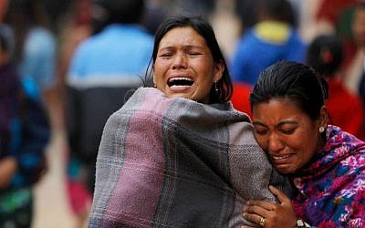 Family members break down during the cremation of an earthquake victim in Bhaktapur near Kathmandu, Nepal, Sunday, April 26, 2015. (AP Photo/Niranjan Shrestha)