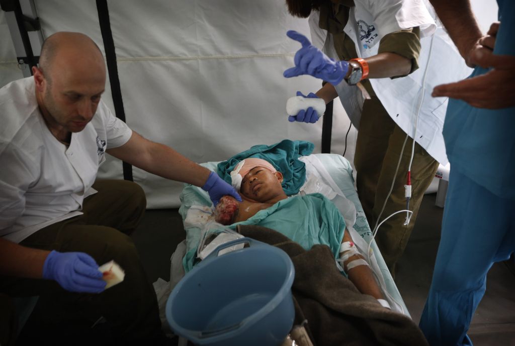 An Israeli doctor treats the wound of an earthquake-affected Nepalese boy, whose arm was amputated in the nearby army hospital and shifted for further treatment to the newly opened Israeli field hospital for earthquake victims in Kathmandu, Nepal, Wednesday, April 29, 2015. (Photo credit: AP/Manish Swarup) An Israeli doctor treats the wound of an earthquake-affected Nepalese boy, whose arm was amputated in the nearby army hospital and shifted for further treatment to the newly opened Israeli field hospital for earthquake victims in Kathmandu, Nepal, Wednesday, April 29, 2015. (Photo credit: AP/Manish Swarup)