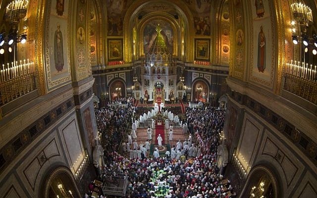 Russian Orthodox Patriarch Kirill, center back, lights candles in the begging of an Easter service in Christ the Savior Cathedral in Moscow, Russia, April 12, 2015. (photo credit: AP/Alexander Zemlianichenko, Pool)