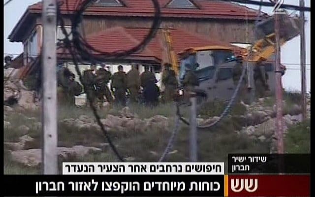 IDF soldiers outside the West Bank village of Beit Anun, near Hebron, searching for an Israeli man who allegedly faked his kidnapping, April 2, 2015. (screen capture: Channel 2) IDF soldiers outside the West Bank village of Beit Anun, near Hebron, searching for an Israeli man who allegedly faked his kidnapping, April 2, 2015. (screen capture: Channel 2)