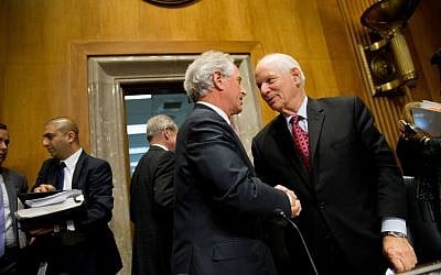 Senate Foreign Relations Committee Chairman Sen. Bob Corker, center, shakes hands with the committee's ranking member Sen. Ben Cardin in Washington, Tuesday, April 14, 2015. (photo credit: AP/Andrew Harnik)