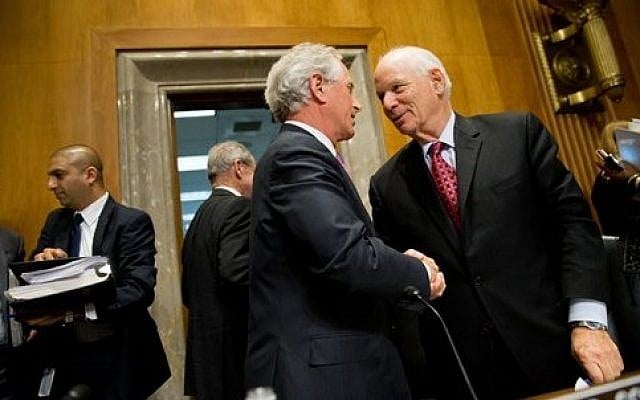 Senate Foreign Relations Committee Chairman Sen. Bob Corker, center, shakes hands with the committee's ranking member Sen. Ben Cardin, on Capitol Hill in Washington, Tuesday, April 14, 2015, after the committee passed the Iran Nuclear Agreement Review Act of 2015. (photo credit: AP Photo/Andrew Harnik)