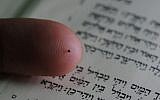The world's smallest bible, printed on a silicon chip the size of a grain of sugar. (photo courtesy of The Israel Museum, Jerusalem)