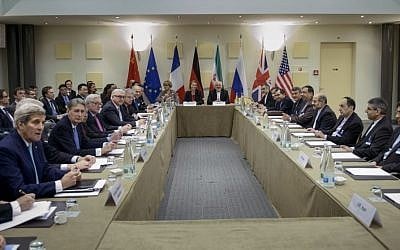 Iranian Foreign Minister Javad Zarif, center right, European Union High Representative Federica Mogherini, center left, and other officials from Britain, China, France, Germany, Russia and the United States wait for the start of a meeting on Iran's nuclear program at the Beau Rivage Palace Hotel in Lausanne, Switzerland Tuesday, March 31, 2015. (photo credit: AP/Brendan Smialowski, Pool)