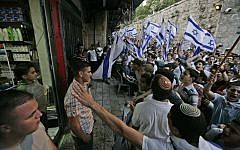Israeli youth chant outside an Arab store in the Old City during Jerusalem Day's 'flag march,' May 21, 2009. (photo credit: Abir Sultan/Flash90)