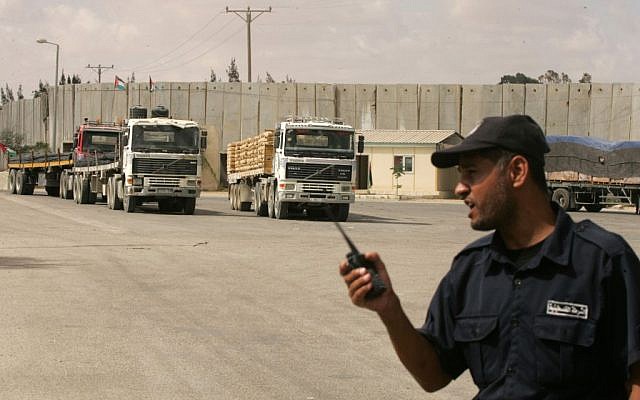 A Palestinian policeman loyal to Hamas stands guard as trucks transporting construction materials enter the Gaza Strip through the Kerem Shalom Crossing on September 22, 2013. (photo credit: Abed Rahim Khatib/Flash90) A Palestinian policeman loyal to Hamas stands guard as trucks transporting construction materials enter the Gaza Strip through the Kerem Shalom Crossing on September 22, 2013. (photo credit: Abed Rahim Khatib/Flash90)