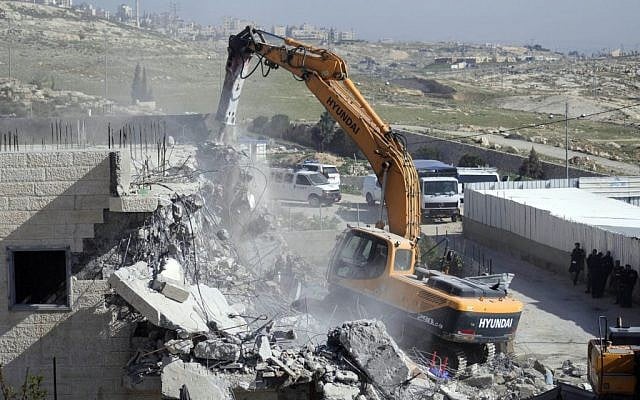 Bulldozers razing a home in East Jerusalem officials say was built illegally in March 2014. (photo credit: Sliman Khader/Flash90)