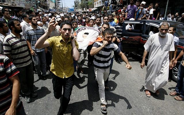 Palestinians carry the body of a Hamas militant killed in an Israeli air strike in Rafah, July 17, 2014. (Abed Rahim Khatib/Flash90) Palestinians carry the body of a Hamas militant killed in an Israeli air strike in Rafah, July 17, 2014. (Abed Rahim Khatib/Flash90)