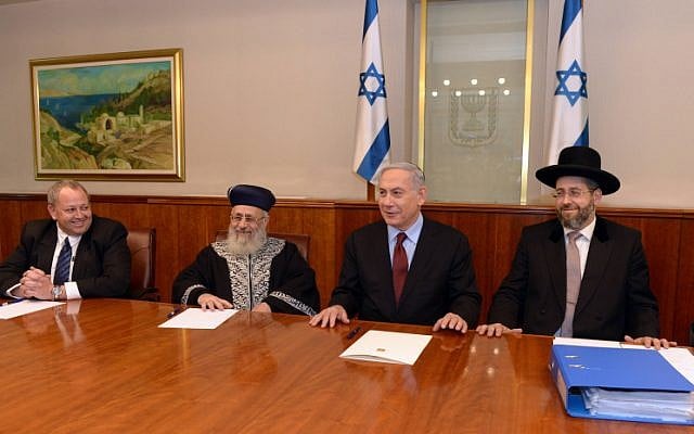 Prime Minister Benjamin Netanyahu (R) seen with Chief Sephardi Rabbi Yitzhak Yosef (2L) and Ashkenazi Chief Rabbi David Lau Jerusalem, during a ceremony to sell the hametz of the state of Israel to Arab Israelis before the upcoming Passover holiday. April 02, 2015. (photo credit: Haim Zach/GPO)