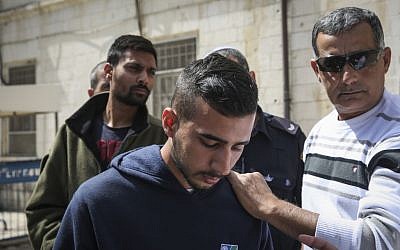 Niv Asraf (front) and his friend Eran Nagauker (left), 22-year-olds from Beersheba, are seen at the Jerusalem Magistrate's Court for remand extension on April 3, 2015, a morning after Asraf was found safe after being falsely reported as missing by his friend Nagauker, who said he went into the Arab village of Beit Anun and never came back. Thousands of Israeli soldiers and special security forces were called to the area (Photo credit: Hadas Parush/Flash90)