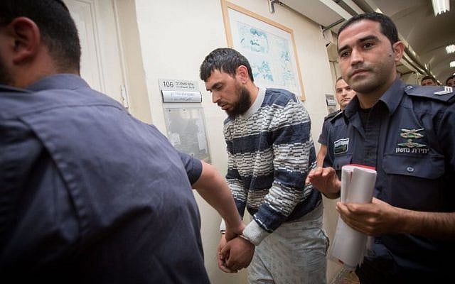 Police escort Khaled Koutineh, who rammed his car into Israeli pedestrians, to a hearing at the Magistrate's Court in Jerusalem. April 16, 2015. (photo credit: Miriam Alster/FLASH90) Police escort Khaled Koutineh, who rammed his car into Israeli pedestrians, to a hearing at the Magistrate's Court in Jerusalem. April 16, 2015. (photo credit: Miriam Alster/FLASH90)
