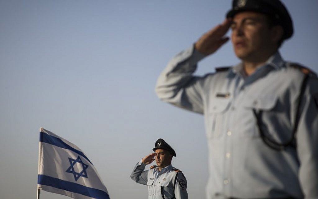 Israeli policemen and women salute the graves of fallen Israeli policemen after laying an Israeli flag on each grave, during a ceremony in the police section of the Mount Herzl Military Cemetery in Jerusalem, on April 19, 2015 (Photo credit: Hadas Parush/Flash90)