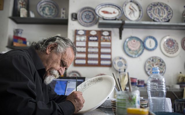 Hagop Antreassian works in his studio for traditional Armenian art, in the Armenian Quarter of Jerusalem's Old City, on April 18, 2015. Hagop's father is a genocide survivor who escaped the massacres in Turkey at the age of 7 and made his way walking through the desert to Jerusalem. This year, on April 24, the Armenians will mark the 100th anniversary of the Armenian Genocide. (photo credit: Hadas Parush/Flash90)