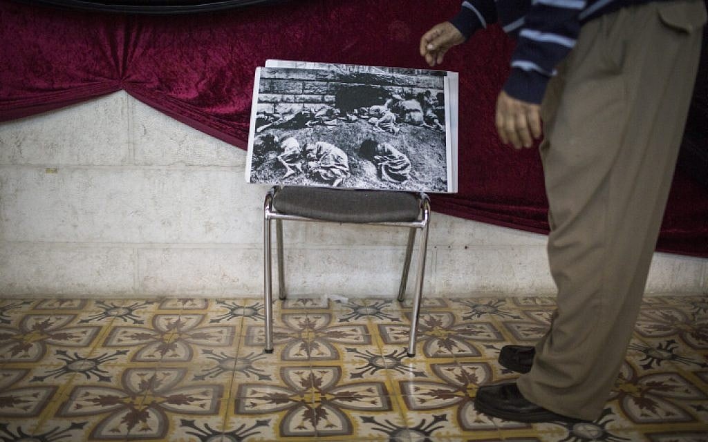 Michael Zakarian organizes archive photographs of the Armenian Genocide, for an exhibition at the Armenian Seminary, on April 15, 2015. This year, on April 24, the Armenians will mark the 100th anniversary of the Armenian Genocide. (photo credit: Hadas Parush/Flash90)