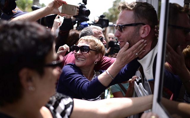 Families and friends greet Israelis who survived the massive earthquake which killed thousands in Nepal, as the survivors arrive to Sde Dov airport in Tel Aviv on a MADA (Magen David Adom in Israel) aircraft. (photo credit: April 27, 2015.)
