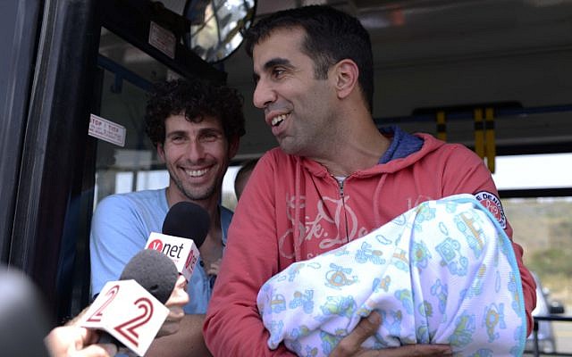 Families and friends greet Israelis who survived the massive earthquake which killed thousands in Nepal, as the survivors arrive to Sde Dov airport in Tel Aviv on a MADA (Magen David Adom in Israel) aircraft. (photo credit: April 27, 2015.)