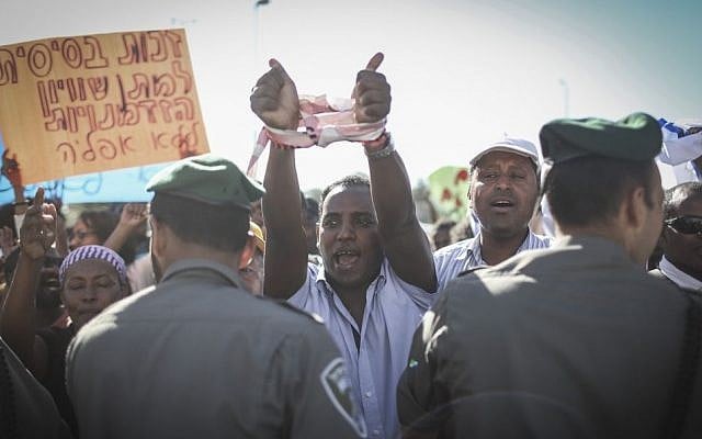 Hundreds of Israeli-Ethiopians protest outside the Police Headquarters in Jerusalem, against violence and racism directed at Israelis of Ethiopian descent, following a video clip released a few days ago showing police beating up an IDF soldier from the Ethiopian community. April 30, 2015. (photo credit: Hadas Parush/FLASH90)