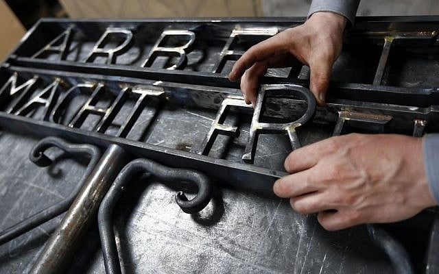 Blacksmith Michael Poitner works on a replica of the Dachau Nazi concentration camp gate with the writing "Arbeit macht frei" (Work Sets you Free) in Biberbach near Dachau, Germany, Thursday, April 16, 2015. (Photo credit: AP/Matthias Schrader) Blacksmith Michael Poitner works on a replica of the Dachau Nazi concentration camp gate with the writing "Arbeit macht frei" (Work Sets you Free) in Biberbach near Dachau, Germany, Thursday, April 16, 2015. (Photo credit: AP/Matthias Schrader)