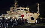 Italian Coast Guard ship Bruno Gregoretti, carrying survivors of the boat that overturned off the coasts of Libya Saturday, arrives at Catania Harbor, Italy, Monday, April 20, 2015. (AP Photo/Carmelo Imbesi)